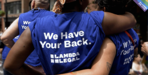pride parade marchers in lambda legal we have your back t-shirts